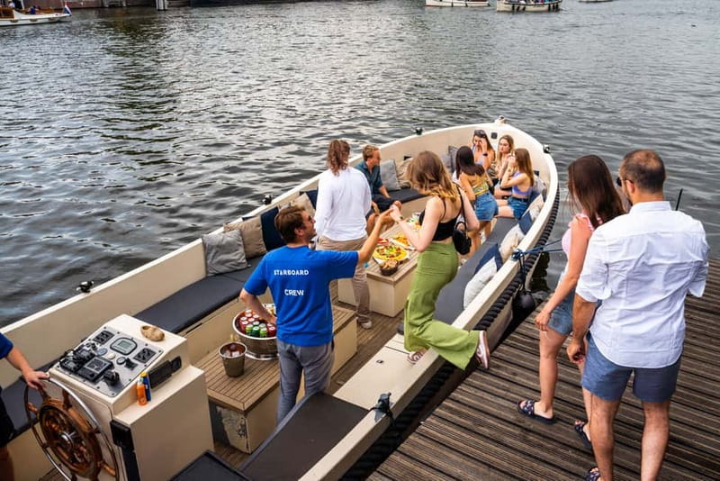 Amsterdam: Spanish Guided Open Boat Cruise with Bar Onboard - Along the Canal Belt