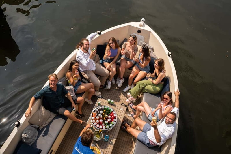 Amsterdam: Spanish Guided Open Boat Cruise with Bar Onboard - Hermitage Museum, the Skinny Bridge, and Amstel Hotel