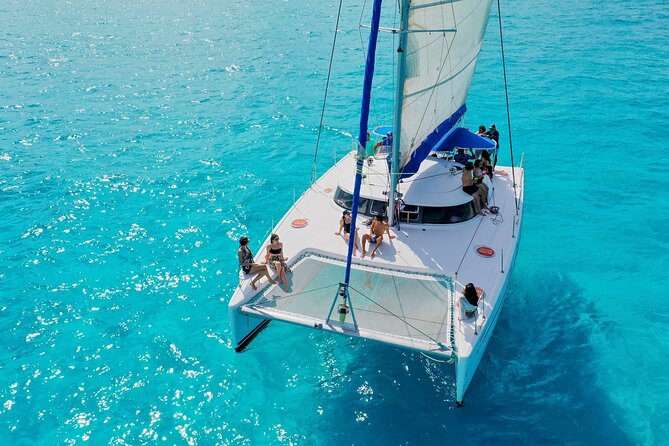 Discover Isla Mujeres: Catamaran, Snorkeling, and "Ice Bar" - Boarding, pier time, and the catamaran ride