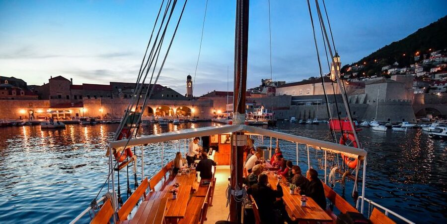 Dubrovnik: Panoramic Sunset Cocktail Cruise Around Old Town - Meeting Slavija in Dubrovnik’s Old Port