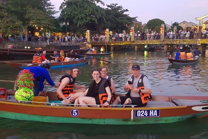 Hoi An Nightlife Tour with Hoi An Ancient Walking Tour, Boat Ride, Night Market - Lighting a lantern for good luck