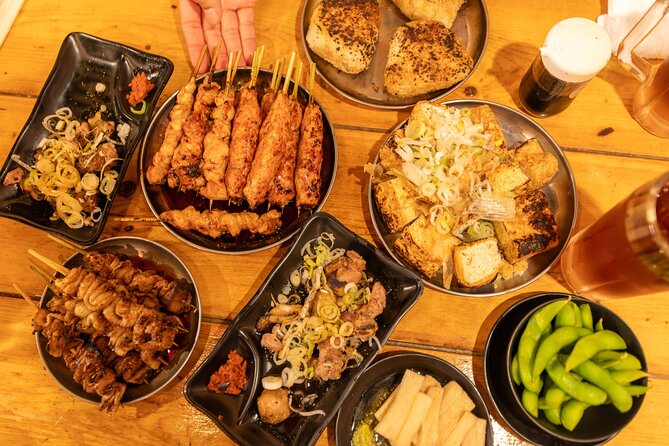 Shinjuku Underground Nightlife Tour: Izakaya Food & Bar Hopping - Walking through Kabukicho’s neon gateway