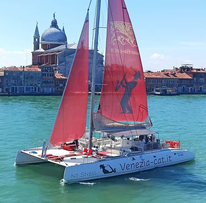 Venice: Golden Hour Cruise with Classical Music & Cocktail - Boarding the spacious catamaran